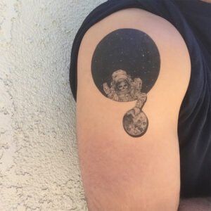 astronaut holding moon tattoo design