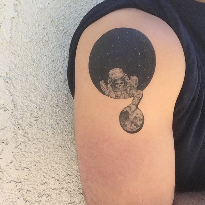 astronaut holding moon tattoo design